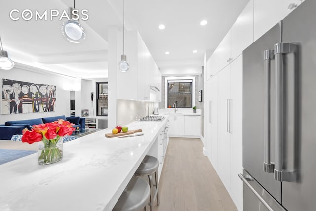 kitchen with recessed lighting, appliances with stainless steel finishes, light wood-style floors, white cabinetry, and modern cabinets