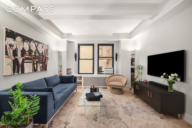 living area with radiator heating unit, baseboards, and cooling unit