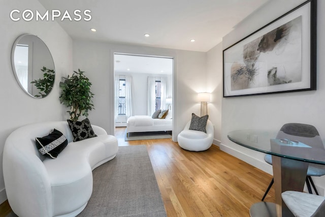 living room with recessed lighting, baseboards, baseboard heating, and wood finished floors