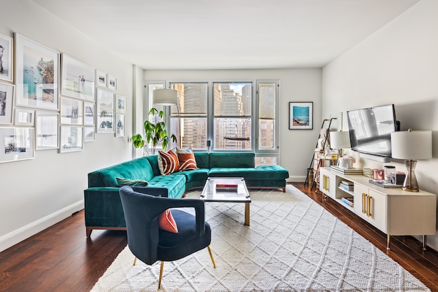 living area with hardwood / wood-style flooring and baseboards