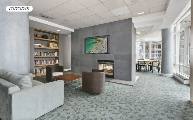 70 Little W St Unit 22G, New York City, NY 10280 - sitting room with a multi sided fireplace, carpet floors, and a paneled ceiling