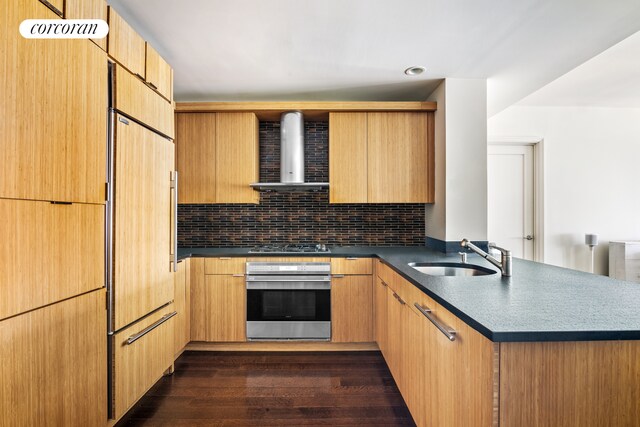 70 Little W St Unit 22G, New York City, NY 10280 - kitchen with oven, wall chimney exhaust hood, a sink, a peninsula, and dark countertops