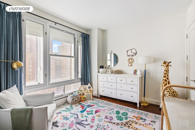 70 Little W St Unit 22G, New York City, NY 10280 - bedroom with baseboards and dark wood-style flooring