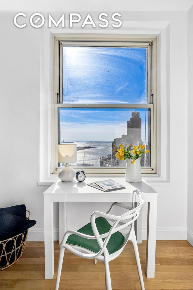 home office featuring baseboards and wood finished floors