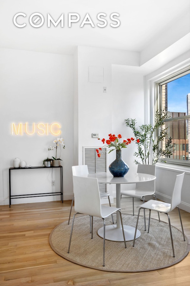 88 Greenwich St Unit 3505, New York City, NY 10006 - dining space featuring wood finished floors and baseboards