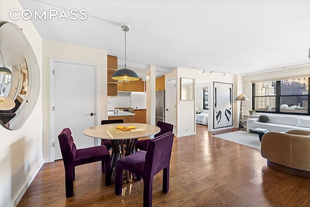 dining room with dark wood-style floors and baseboards