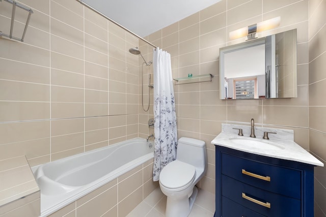 full bath featuring toilet, tiled shower / bath, tile walls, and vanity