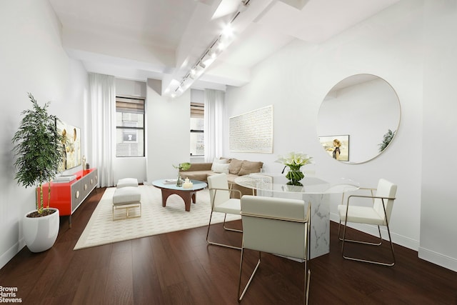 living area with track lighting, baseboards, and wood finished floors