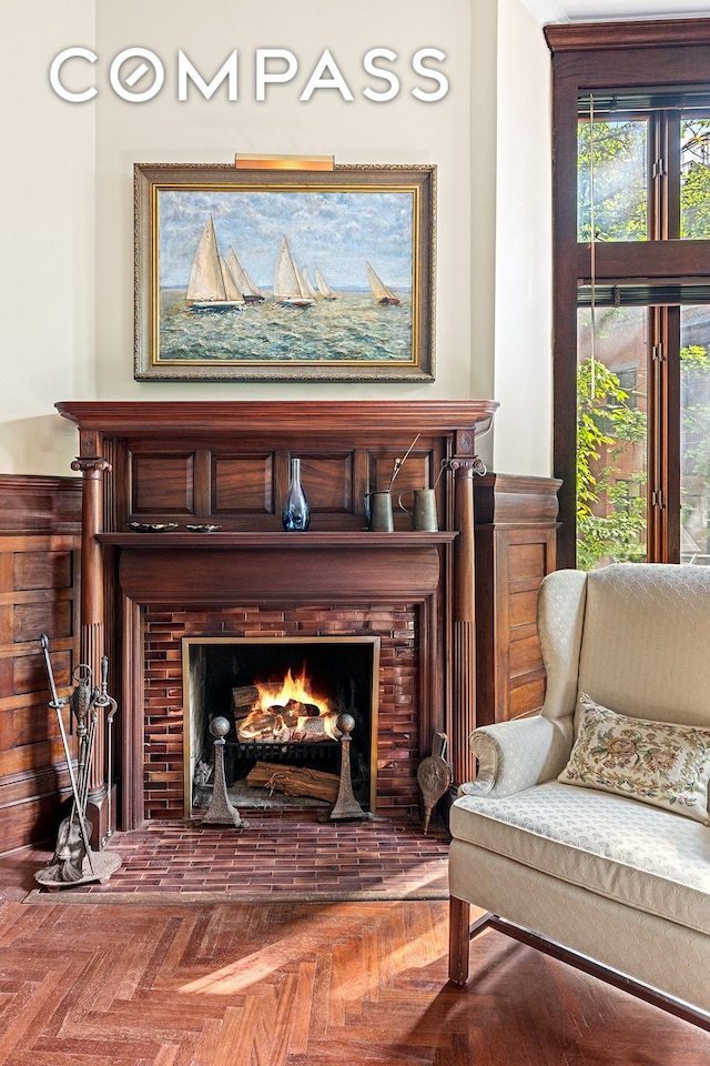 sitting room featuring a warm lit fireplace