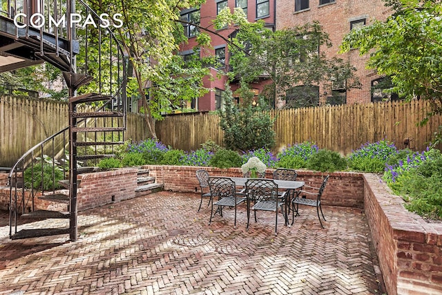 view of patio featuring outdoor dining space and a fenced backyard