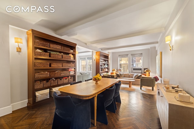 dining room featuring beamed ceiling and baseboards