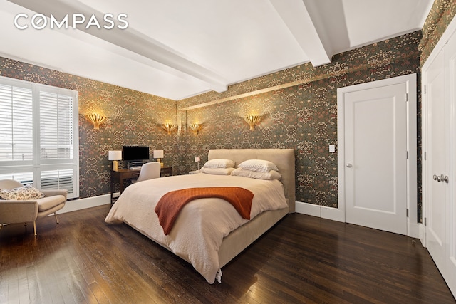 bedroom with baseboards, beamed ceiling, wood-type flooring, and wallpapered walls