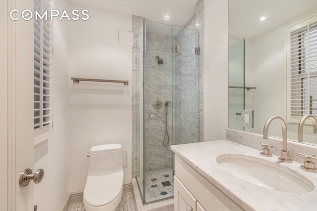 bathroom featuring toilet, a shower stall, recessed lighting, and vanity