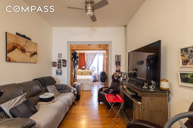 living area with light wood-type flooring and ceiling fan