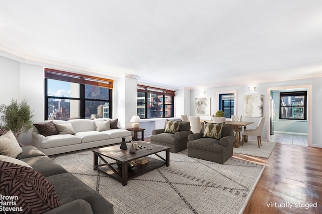 living area with baseboards and wood finished floors