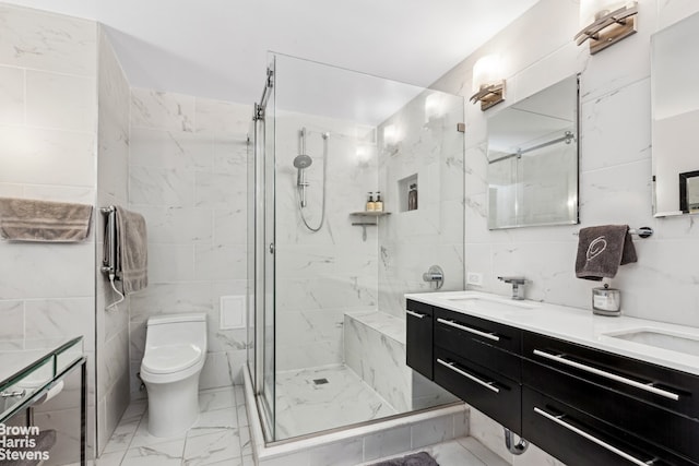 305 E 40th St Unit 17Jk, New York City, NY 10017 - bathroom featuring tile walls, marble look tiles, a marble finish shower, toilet, and double vanity