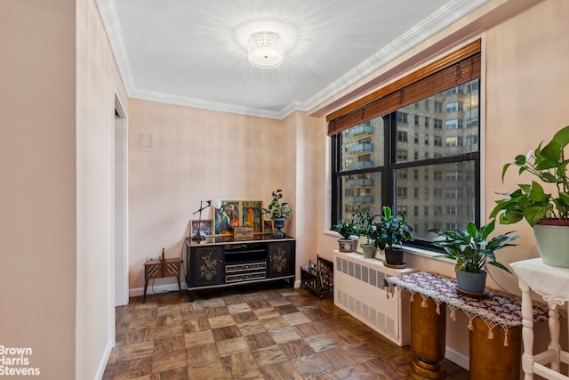 interior space with ornamental molding, baseboards, and radiator heating unit