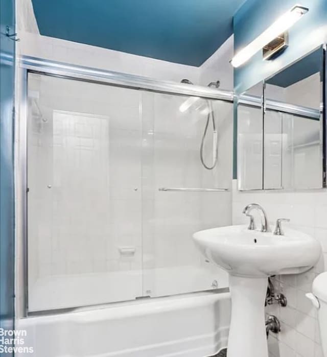 305 E 40th St Unit 17Jk, New York City, NY 10017 - full bathroom featuring toilet and combined bath / shower with glass door