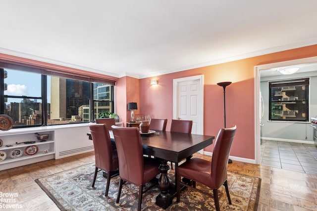 dining area featuring ornamental molding and baseboards