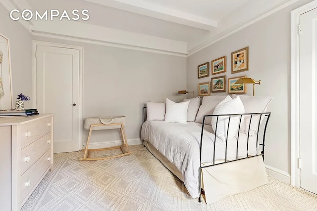 bedroom with beam ceiling and baseboards