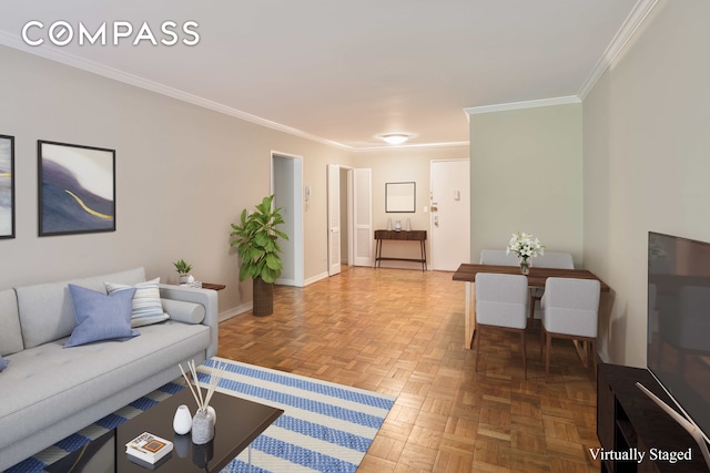 living area with baseboards and ornamental molding