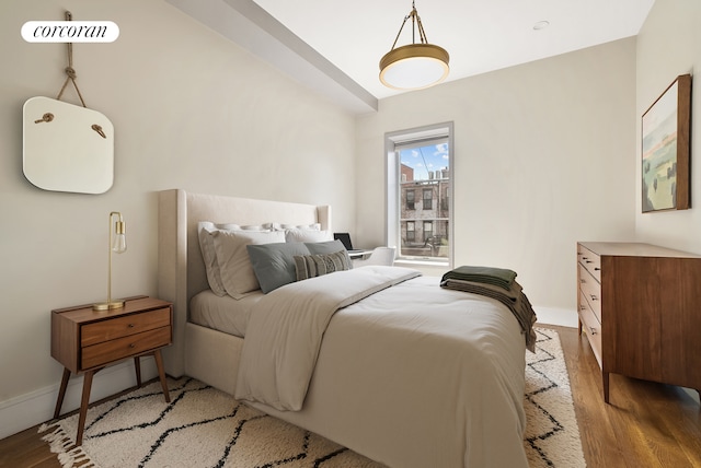 bedroom with light wood-style floors and baseboards