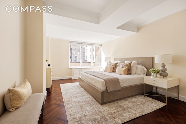 bedroom with ornamental molding and baseboards