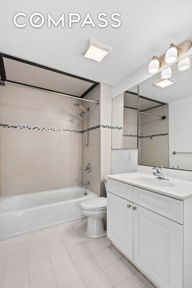 bathroom featuring toilet, vanity, bathing tub / shower combination, and tile patterned floors