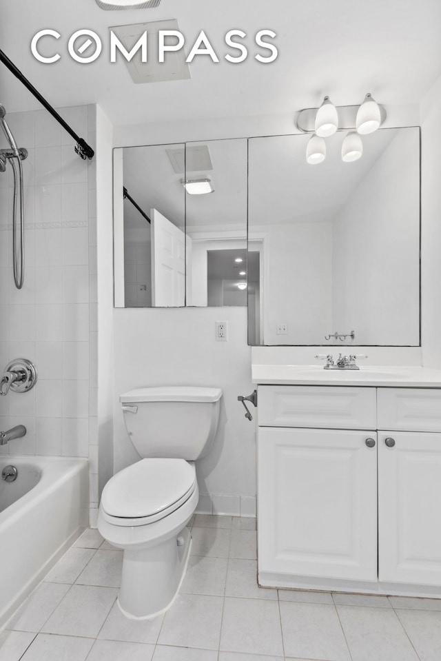 bathroom with baseboards, bathing tub / shower combination, toilet, tile patterned floors, and vanity