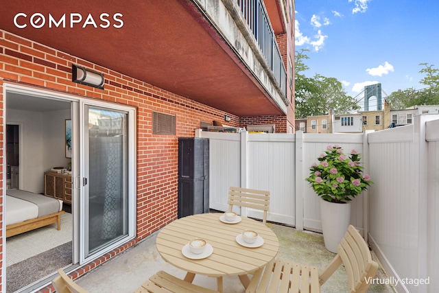 view of patio / terrace featuring fence