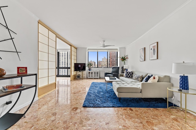 living room featuring ceiling fan, baseboards, marble finish floor, expansive windows, and crown molding