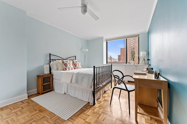 bedroom featuring ornamental molding, a view of city, ceiling fan, and baseboards