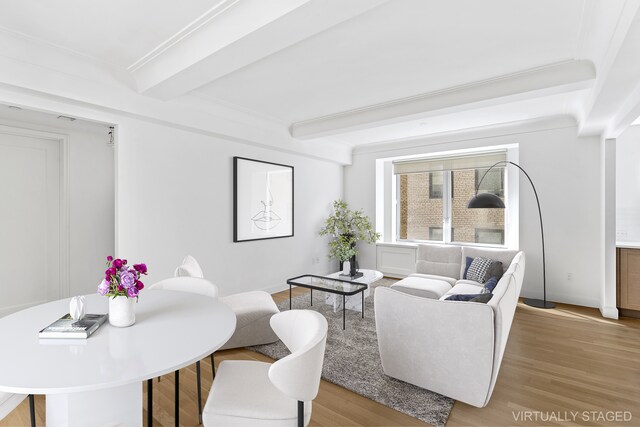 living area with beamed ceiling and wood finished floors