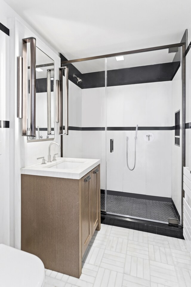 full bath with a shower stall and vanity