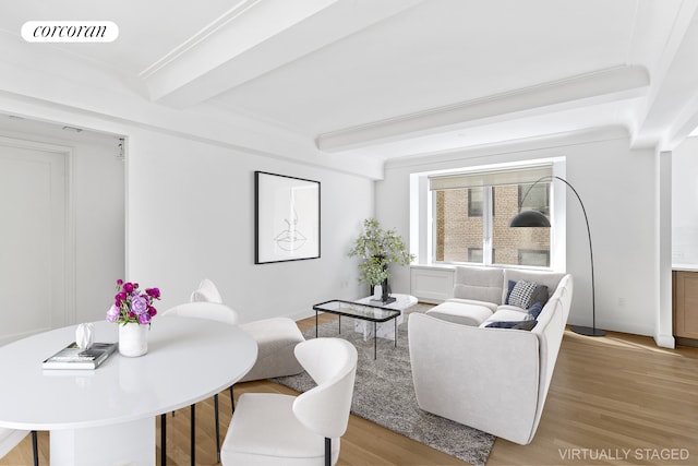 living room with visible vents, beamed ceiling, and wood finished floors