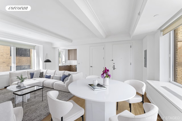 dining space featuring electric panel, visible vents, beam ceiling, and wood finished floors