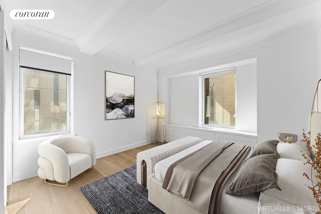 bedroom with beam ceiling, visible vents, light wood finished floors, and multiple windows