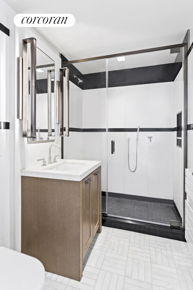 bathroom featuring a stall shower and vanity