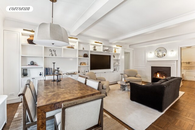 living room with a lit fireplace, visible vents, a decorative wall, and beamed ceiling