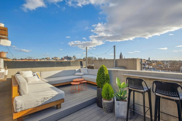 wooden deck featuring a view of city, outdoor dry bar, and an outdoor living space