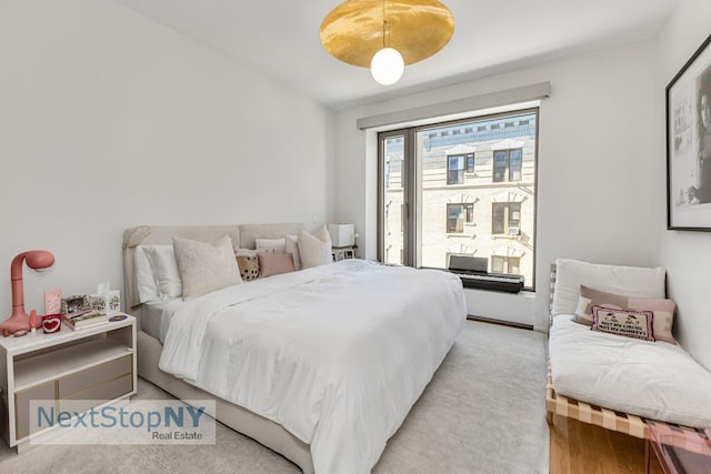 bedroom with light colored carpet