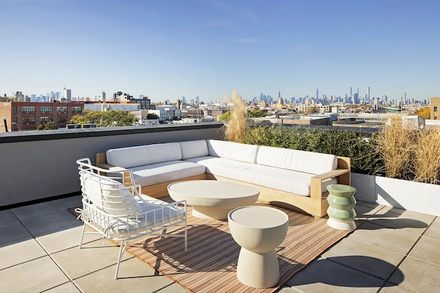 view of patio with a balcony, outdoor lounge area, and a city view