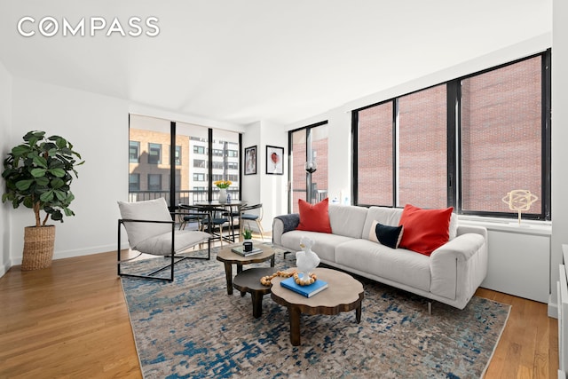 living area with light wood-style floors and baseboards