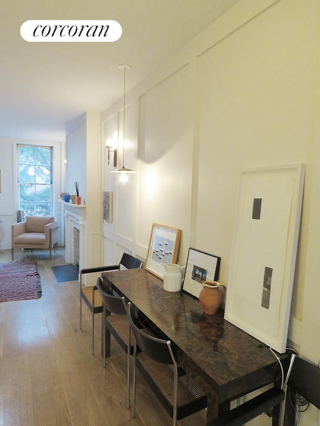 dining room with a glass covered fireplace and light wood-style flooring