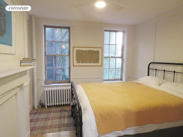 bedroom featuring radiator heating unit and a ceiling fan