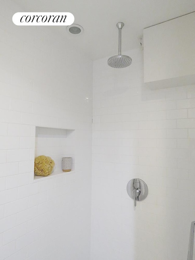 interior details featuring tiled shower