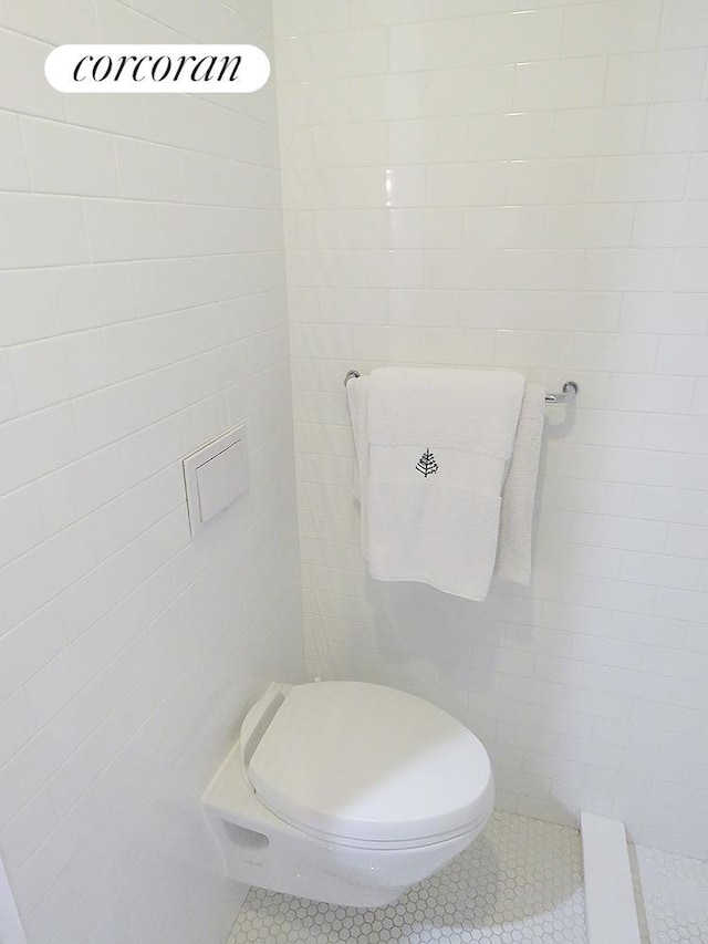 bathroom with tile walls and tile patterned floors