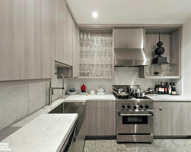 kitchen with tasteful backsplash, modern cabinets, wall chimney exhaust hood, and high end stainless steel range