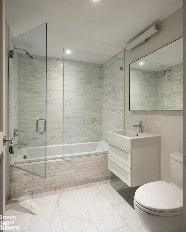 full bathroom with tiled shower / bath, vanity, and toilet