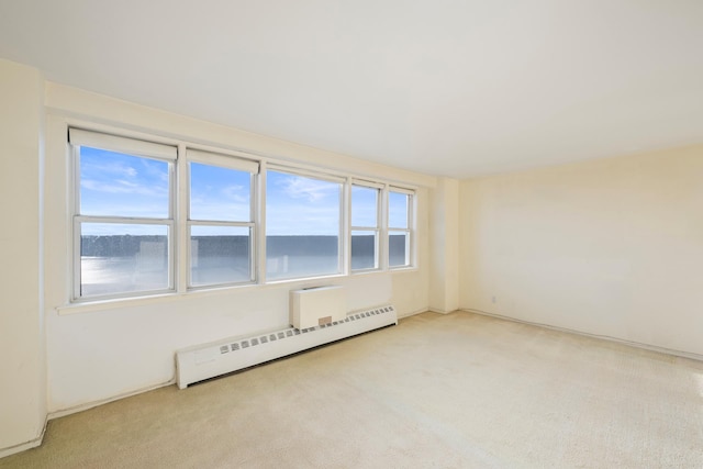 empty room with carpet floors and baseboard heating